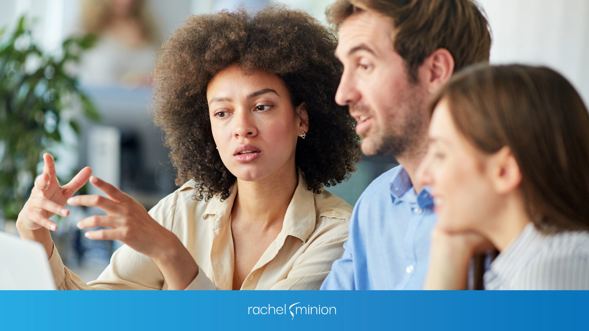 Marketing team talking while looking at a computer