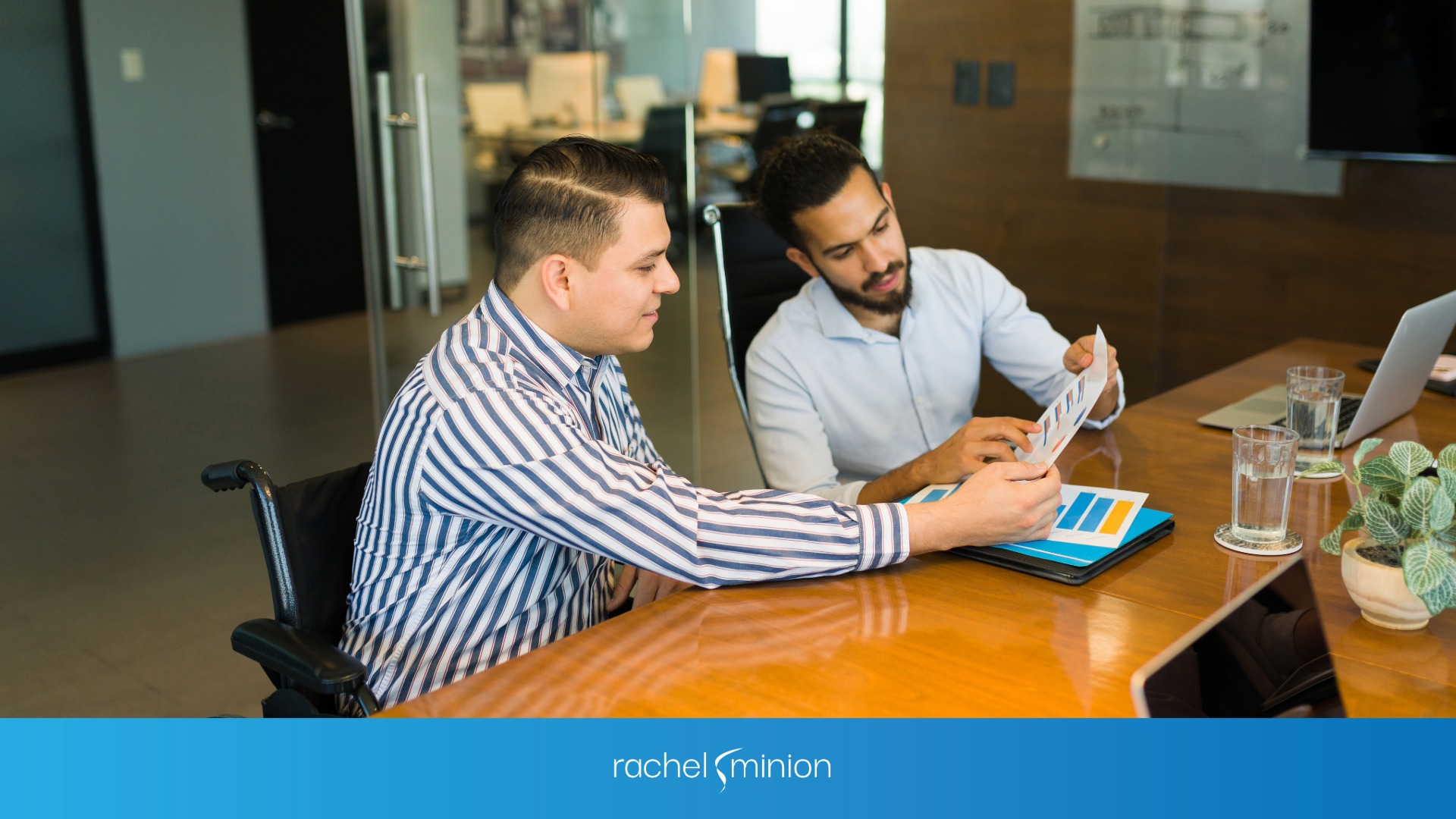Two men looking at a report for the brand