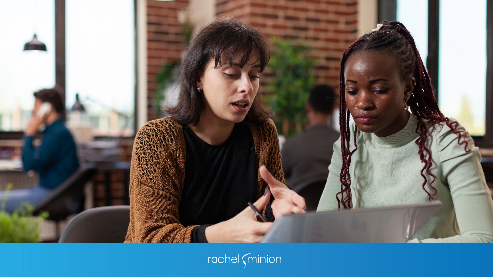 Two women working on laptop