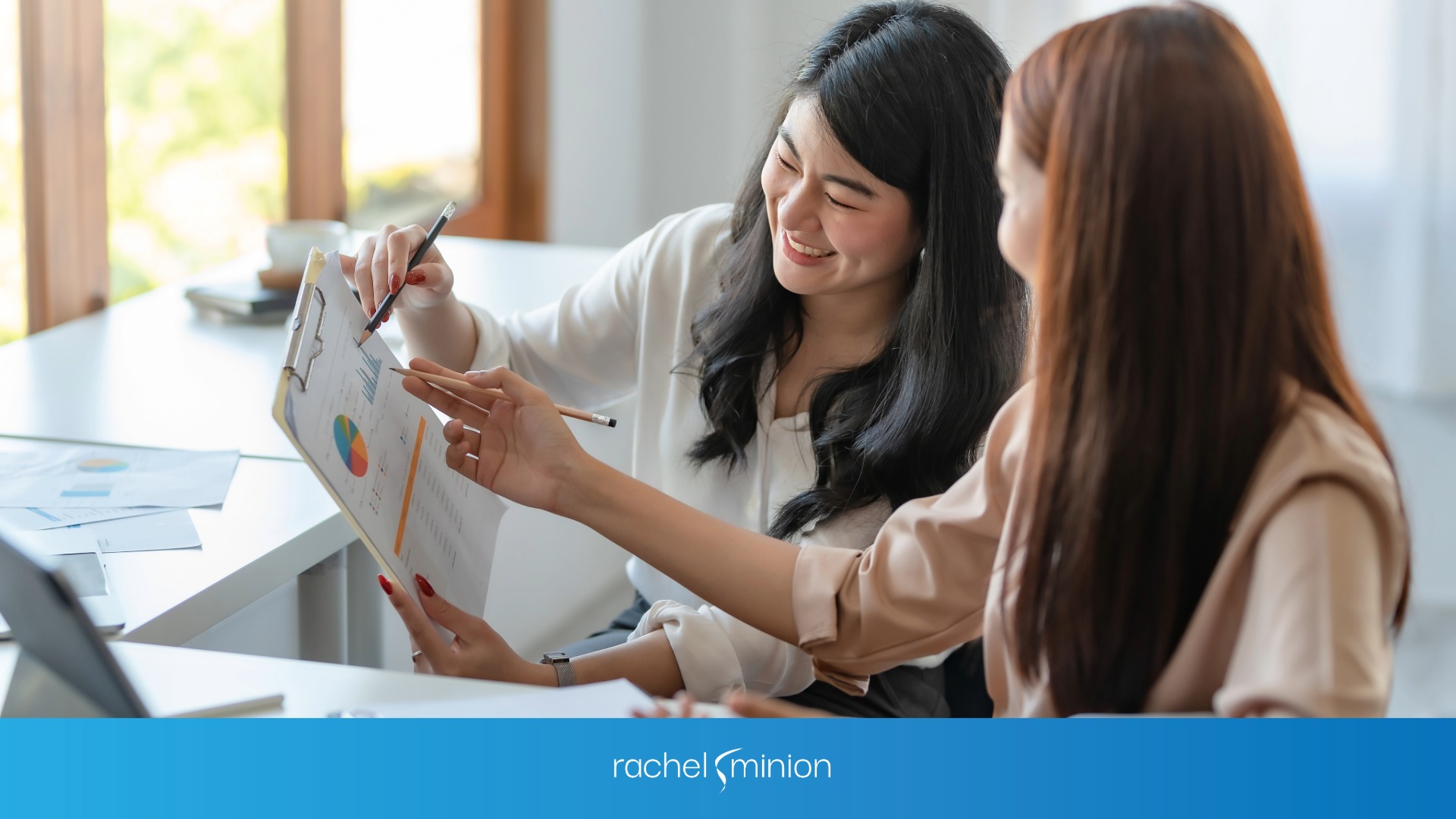 Two women working with conversion data